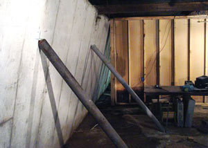 A severely tilting foundation wall propped up by steel beams in Upper Darby.