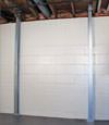 A steel i-beam system installed on a Aston foundation wall