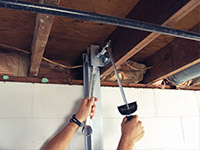 Straightening a foundation wall with the PowerBrace™ i-beam system in a Cherry Hill home.