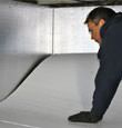 contractor installing TerraBlock™ floor insulation in a Owings Mills crawl space