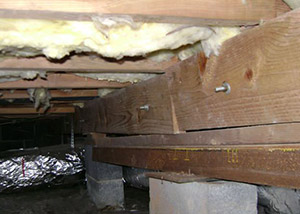 sagging crawl space with wooden shimming a Towson crawl space