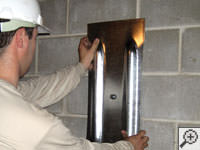 Mounting a foundation wall plate for an earth anchor installation