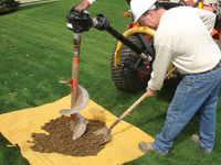 Auguring a hole in the earth for a foundation wall repair system in Owings Mills