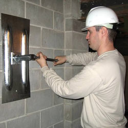 installing a wall anchor to repair an bowing foundation wall in Haverford