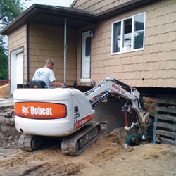 Excavating to expose the foundation walls and footings for a replacement job in Gwynn Oak