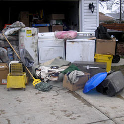 Soaked, wet personal items sitting in a driveway, including a washer and dryer in Lancaster.