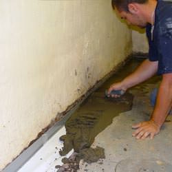 A basement waterproofer installing a perimeter drain system in Nottingham