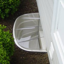 A vinyl basement window and covered window well in Chester Springs