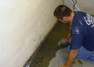 Restoring a concrete slab floor with fresh concrete after jackhammering it and installing a drain system in Thornton.