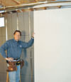 Installing wall panels on top of our basement wall insulation in Lancaster