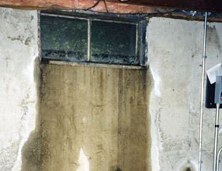 Water pouring out from a basement window in Upper Darby